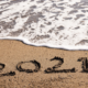 2021 written in sand on the beach